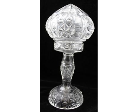 A 20TH CENTURY CUT GLASS LAMP having pointed top to the shade, on stem and raised base, 38cm high 