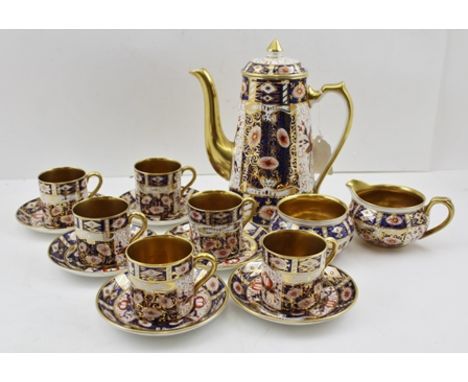 A CARLTON WARE CERAMIC COFFEE SERVICE, gilded and decorated in the Imari palette, comprising coffee pot, sugar bowl, cream ju