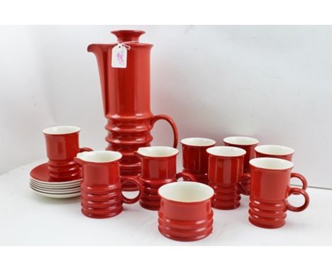 A CARLTON WARE 1970's CERAMIC COFFEE SERVICE, red glazed, the lidded pot of ridged cylindrical form, together with two milk j