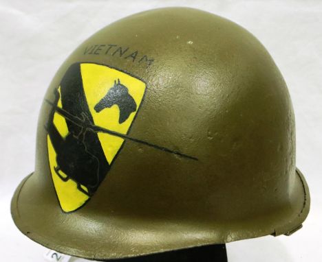 An American Vietnam war period M1 helmet, later painted with 1st Cavalry Division emblem. P&amp;P Group 2 (£18+VAT for the fi