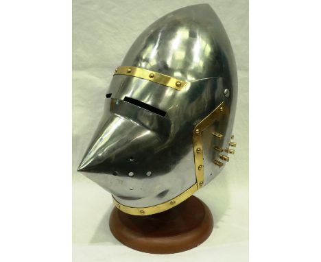 A replica steel nights helmet, brass mounted with visor and leather liner. P&amp;P Group 2 (£18+VAT for the first lot and £3+