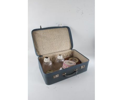 1960's blue suitcase, containing an Art Deco mantel clock, a pair of frilled glass light shades, Noilly Prat advertising asht