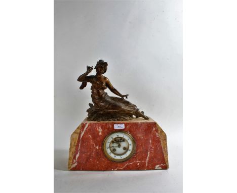 Early 20th century marble mantle clock with a gilded spelter figure of a reclining lady, white dial with roman numerals toget