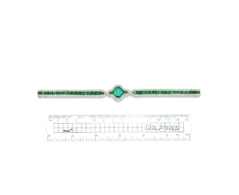 An art deco emerald and diamond bracelet, circa 1920The central lozenge set with a square step-cut emerald between calibré-cu