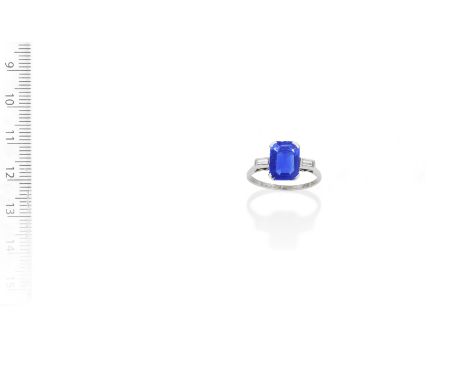 A sapphire and diamond ring, circa 1950The step-cut sapphire, weighing 3.51 carats, between baguette-cut diamond shoulders, r