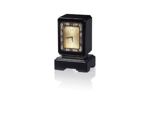 A black onyx and gilt brass desk clock, by Cartier, circa 1930The rectangular black onyx case with shaped corners, on a geome