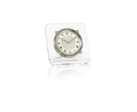 A rock crystal, diamond and silver travelling timepiece, by Cartier, circa 1928The square rock crystal frame with shaped corn