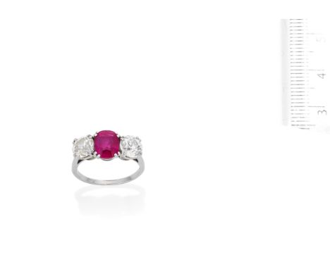 A mid 20th Century pink sapphire and diamond three-stone ringThe cushion-shaped pink sapphire, weighing 2.33 carats, between 