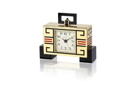 A gilt brass, enamel and sapphire alarm clock, by Cartier, circa 1980Of Art Deco style, the rectangular case with applied red