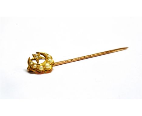 A CASED VICTORIAN CRESCENT MOON AND STAR STICK PIN The stick pin head made up of a graduated seed pearl crescent moon with a 