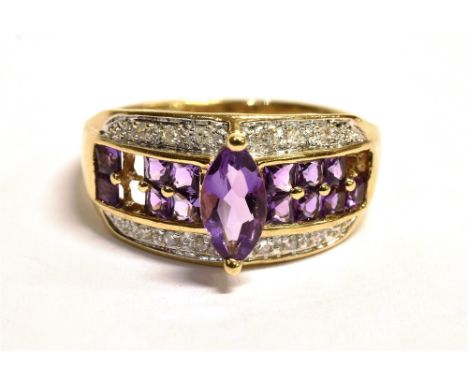 QVC 9CT GOLD GEMSET CLUSTER RING The cluster comprising of a central band of small round cut purple gemstones set with a marq