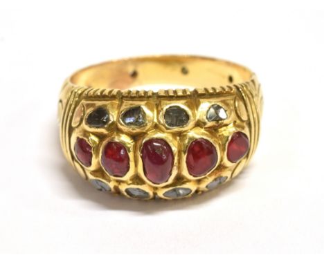 A RUBY AND SAPPHIRE CLUSTER RING The horizontal dome cluster set with five graduated oval rubies and eight small sapphires, r