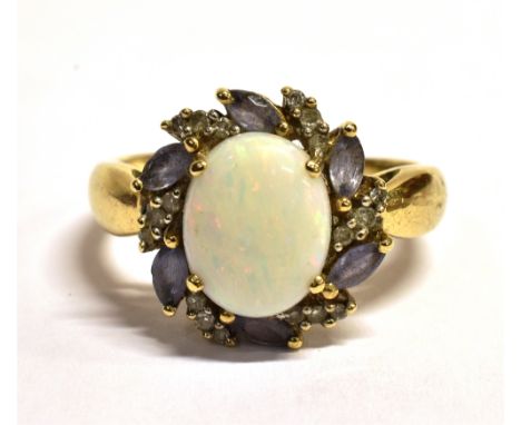 QVC 9CT GOLD OPAL CLUSTER RING The oval white Pinfire opal measuring approx 1 x 0.8cm in a mount of small grey/lilac gemstone