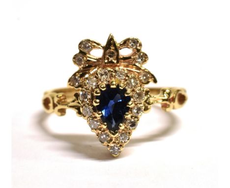 9CT GOLD, SAPPHIRE AND DIAMOND CLUSTER RING The dark blue pear cut sapphire mounted with diamonds with an open work diamond d