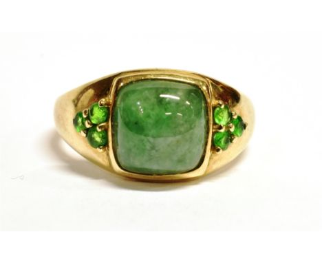 QVC 9CT GOLD GEM SET DRESS RING The ring set with a cushion cut jade type stone measuring 9 x 9mm with three small green gems