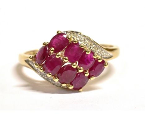 QVC 9CT GOLD RUBY WRAP OVER CLUSTER RING The cluster with white metal and flecked clear stone accents to the borders, measuri