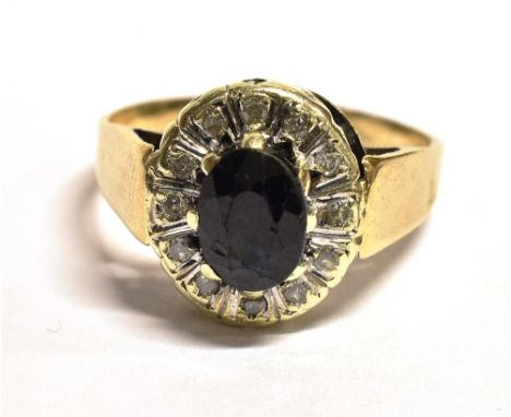 A SAPPHIRE AND DIAMOND CLUSTER RING The near black sapphire mounted with diamonds on an unmarked yellow metal band assessed a