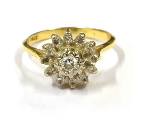 A VINTAGE STAMPED 18 DAISY DIAMOND RING daisy size 1cm, ring size K, weight 2.7grams