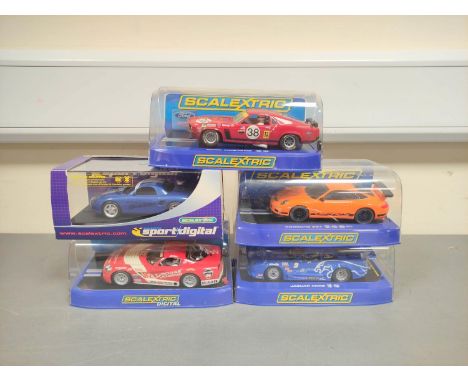 Scalextric. Five 1/32 scale racing car models in perspex cases to include Porsche 997 C2871, Ford Mustang No38 C3107, Jaguar 