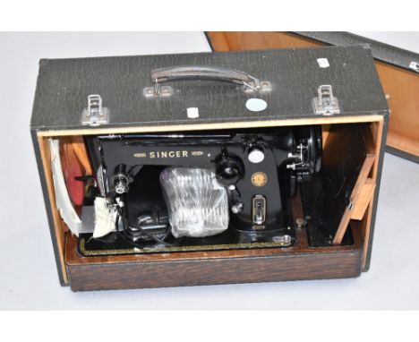 A vintage Singer sewing machine in integral wooden case, with Crocodile effect finish , model 306K, electric driven