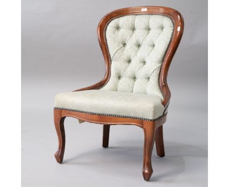 A reproduction nursing chair having stained frame and button back , upholstered in jade green , width approx. 58cm