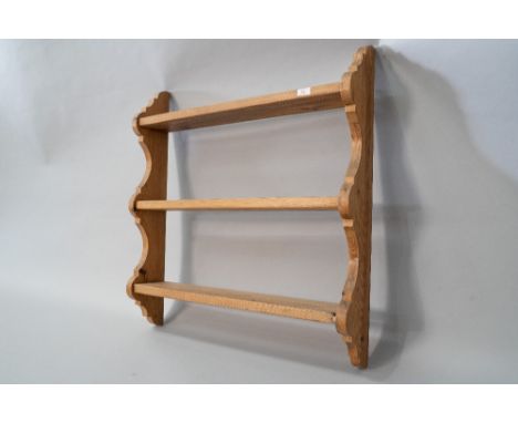 A natural pine triple wall shelf of small proportions with plate grooves to each and shaped ends, width approx. 74cm