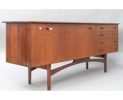 A vintage teak sideboard, in the Long John style , having wide drop flap cocktail or similar section and four side drawers, l