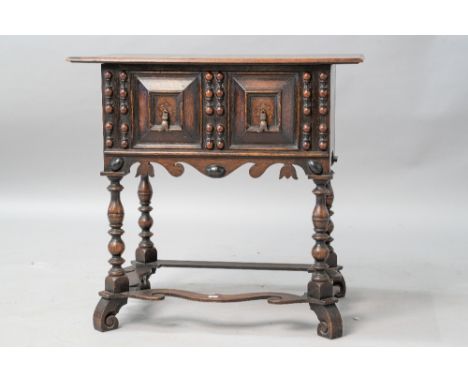 A 19th Century Jacobean style side table having single frieze drawer with double cushion and handles, turned legs and shaped 