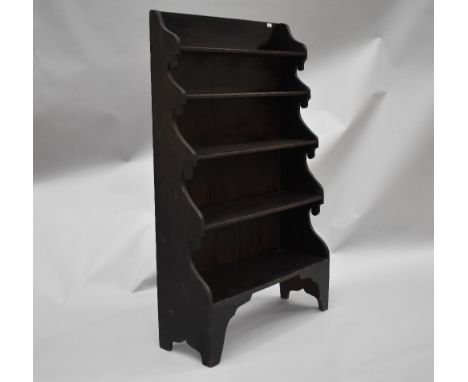 A 19th Century stained frame waterfall bookcase, in the naive style having shaped ends and feet, width approx. 92cm, height 1