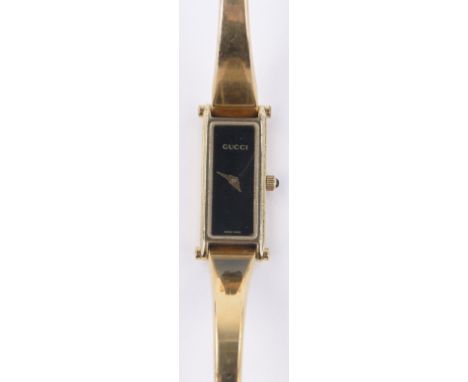 A lady's Gucci 1500L gold plated bangle wristwatch,black dial, case width 12mm, boxed, working order.