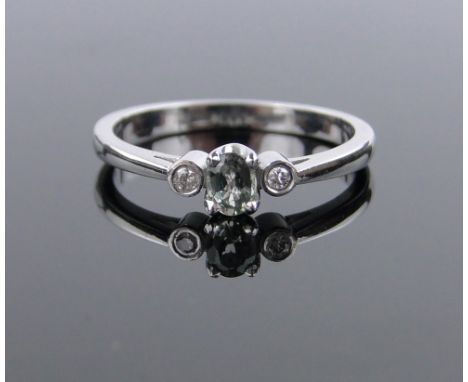 A 9ct white gold 3 stone green sapphire and diamond ring,size M.