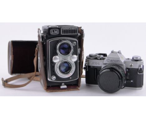 A Yashica LM twin lens reflex camera,leather cased.