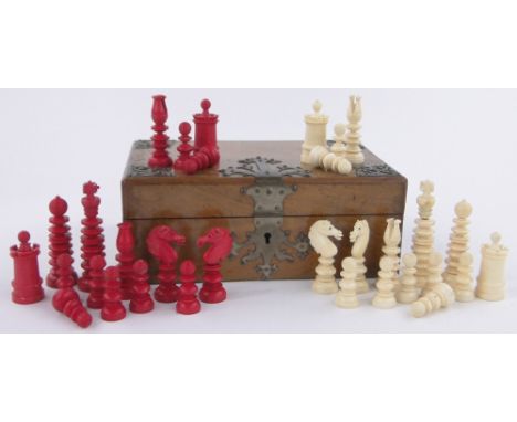 A 19th century red and white stained carved bone chess set,King height 8cm, brass bound walnut box.