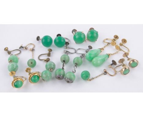 A group of various jade earrings.