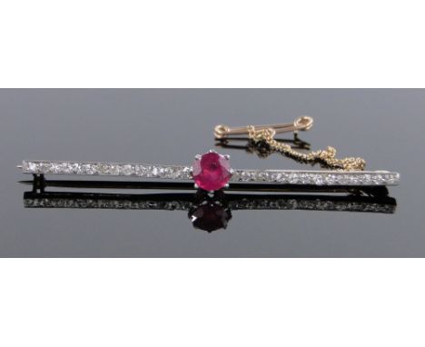 An unmarked gold platinum ruby and diamond set bar brooch,length 55mm.