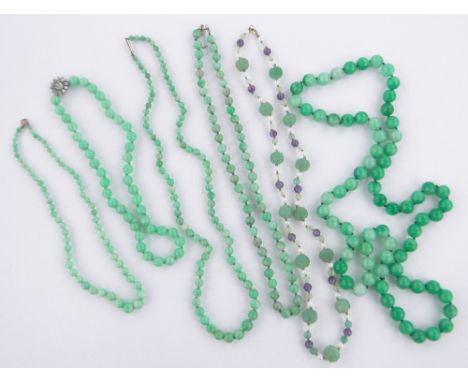 A group of jade bead necklaces.