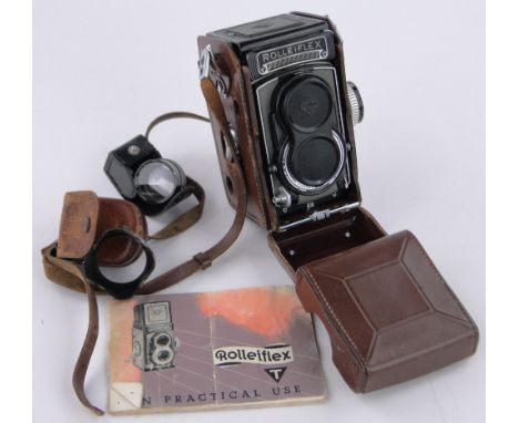 A Rolleiflex twin lens reflex camera,leather cased with instructions.