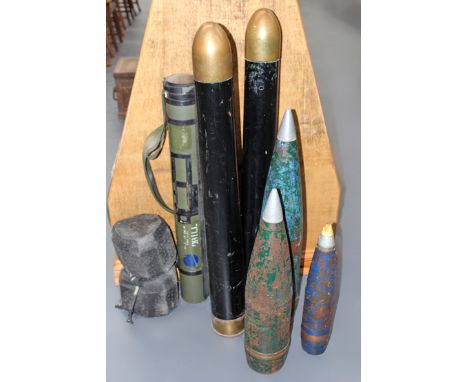 A collection of various dummy field gun ammunition and projectiles.
