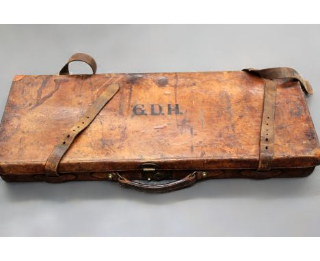A vintage leather double shot gun case with Army and Navy trade label.