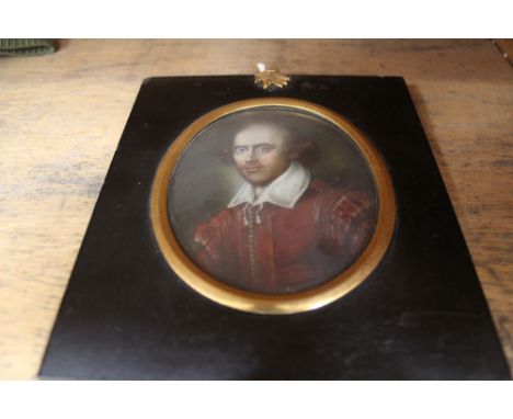 A 19th Century oval miniature portrait of a young man in red coat and white shirt, 102 x 84mm.