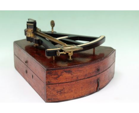 An 18th/19th Century ebony and brass octant with ivory scale. Signed Hughs, London. In period mahogany box with McMillan & Ta