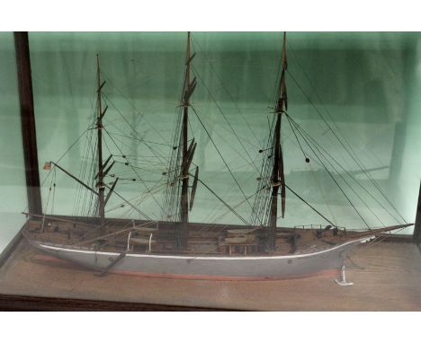 A cased hand built scale waterline model of a three masted sailing vessel. Fully rigged. Case 45 x 59cm.