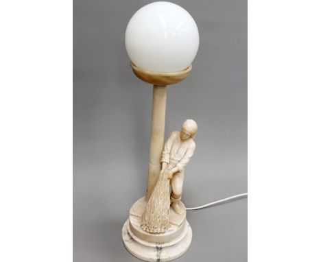 An Art Deco period carved alabaster table lamp in the form of a fisherman hauling nets. 51cm high (plus globe shade).