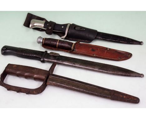 A WWII period German dress bayonet, a similar period Mauser bayonet, a knuckle duster knife and a later hunting knife togethe