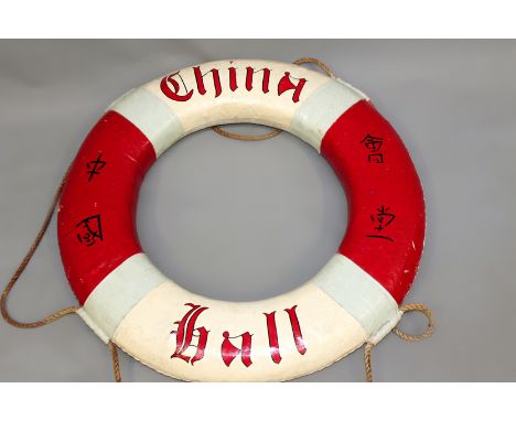 A vintage “China Hall” life ring. Red and white with character designs. 80cm diameter.