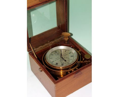 A Thomas Mercer Ltd marine chronometer. Serial no 19446 - gimble mounted in mahogany case with glazed top.