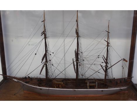 A cased hand built scale model of a three masted sailing vessel. Fully rigged. Case 35 x 28cm.