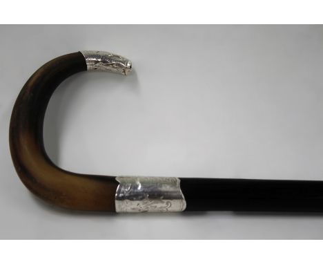 A gentleman’s ebony walking stick with rhinoceros horn handle and silver coloured mounts. 80cm long.
N.B.Non EU buyers please