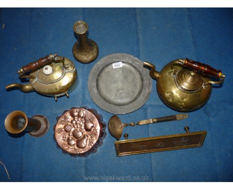 A small quantity of brass including two kettles, ladle, bud vase, wall plaque, copper jelly mould, etc.
