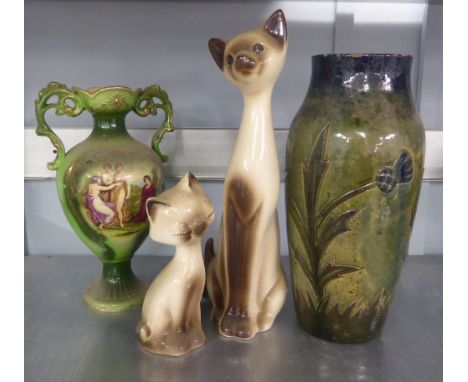 A VICTORIAN POTTERY TWO HANDLED VASE,  PAINTED WITH CLASSICAL FIGURES AND THREE CERAMIC MODELS OF CATS AND A GLAZED GREEN VAS